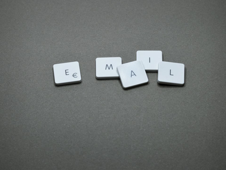 Letter tiles spelling the word email on a grey surface